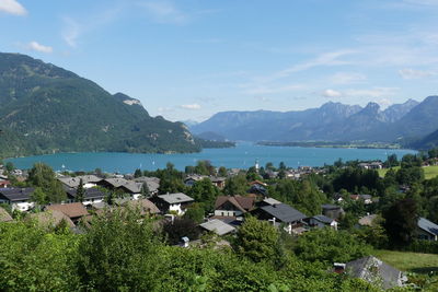 Scenic view of townscape by sea against sky