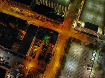 High angle view of illuminated street amidst buildings in city