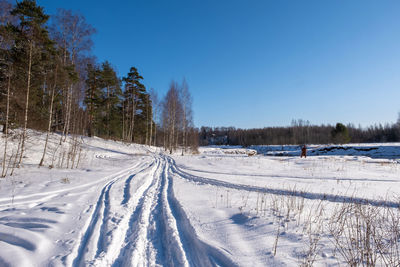 Snow covered field against sky