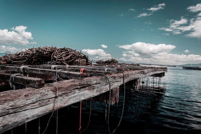 View of old boat in sea against sky