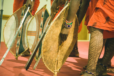 Low section of people in masai costume performing on stage