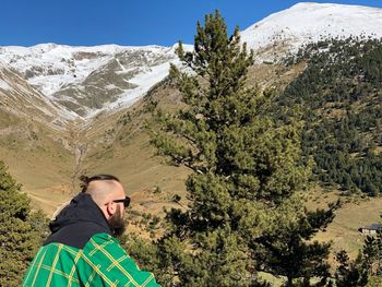 Man looking at view of mountains during winter