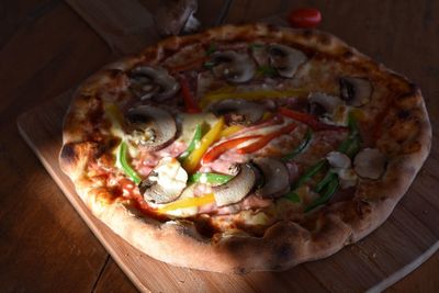 High angle view of pizza on cutting board