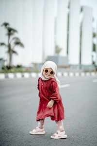 Portrait of young woman standing on street