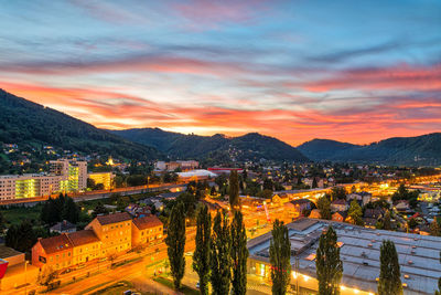 High angle view of illuminated cityscape against sky during sunset