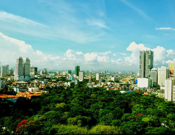 Trees and buildings against sky