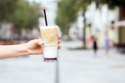 Close-up of hand holding drink