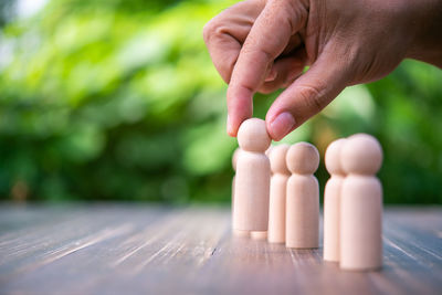 Cropped hand of person playing block on table