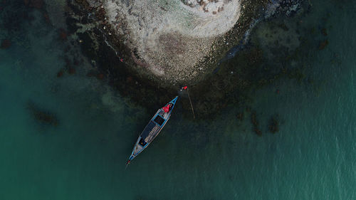High angle view of couple relaxing on a boat .