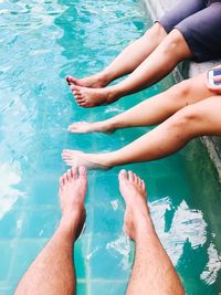 Low section of woman feet in swimming pool