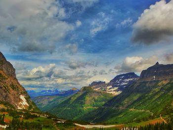 Scenic view of mountains against cloudy sky