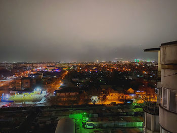 High angle view of illuminated buildings in city at night