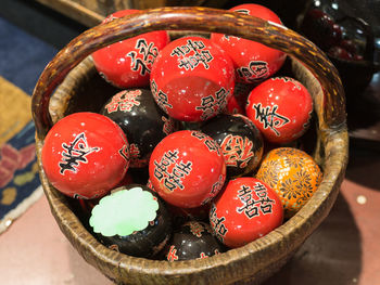 Group of colorful japanese hand-painted spheres inside a basket.