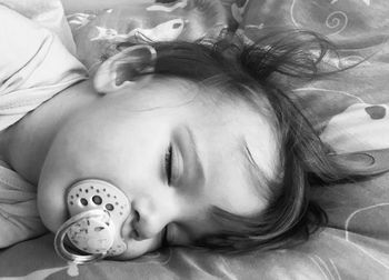 High angle view of baby sleeping on bed