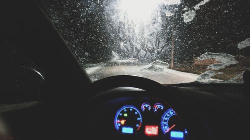 Close-up of hand on car windshield