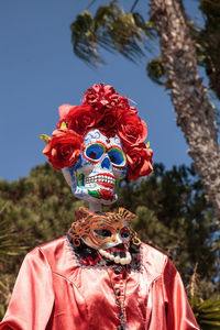 Midsection of man with red umbrella