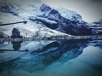 Scenic view of frozen lake against mountain range