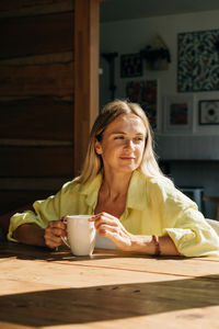 Portrait of woman sitting on table