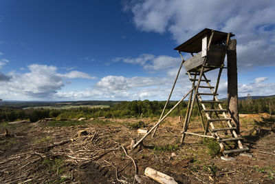 Traditional windmill on field against sky