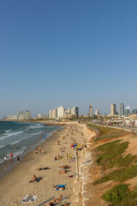 High angle view of beach and buildings against clear blue sky