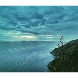 Scenic view of sea against cloudy sky