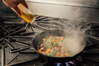 Cropped hands making food in kitchen at home