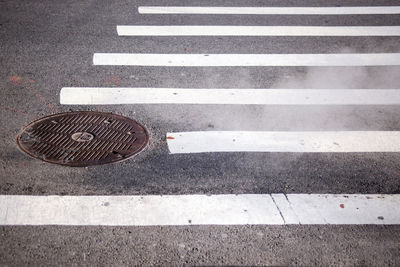 Close-up of zebra crossing on street