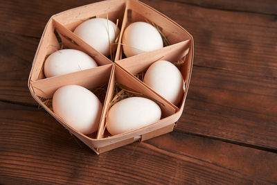 High angle view of eggs in basket on table