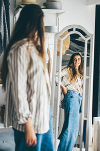 Side view of young woman using mobile phone
