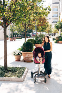 Full length of mother and daughter on tree