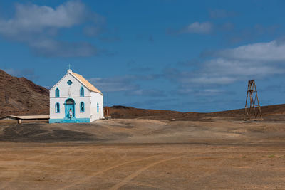 Built structure on beach against sky