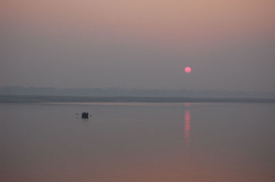 Scenic view of sea against sky at sunset