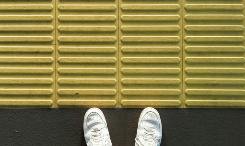 Low section of person standing on footpath