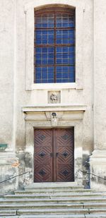 Low angle view of window and door on building