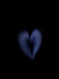 Close-up of heart shape over black background