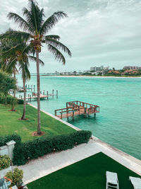 Scenic view of swimming pool by sea against sky