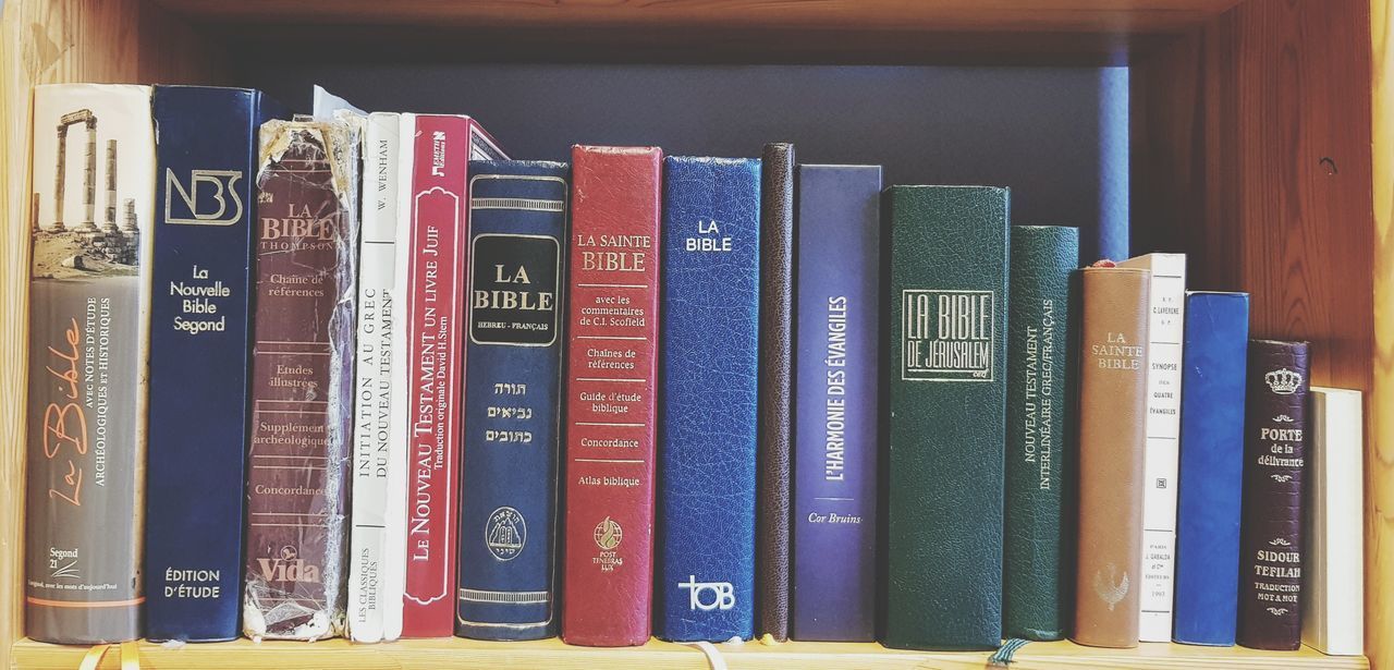 CLOSE-UP OF BOOKS IN SHELF AT HOME
