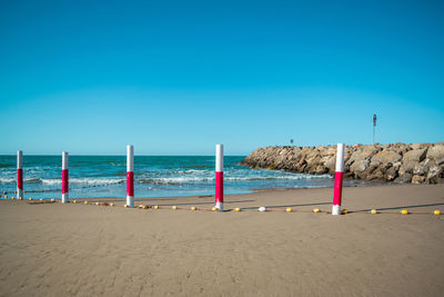 Scenic view of beach against clear blue sky