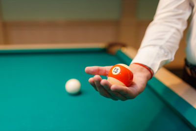 Cropped hand playing pool