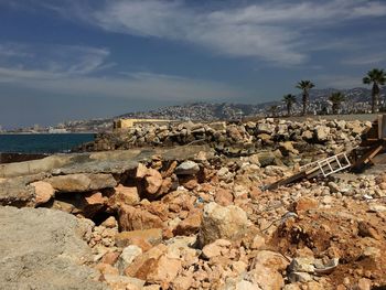 Panoramic shot of rocks on beach against sky