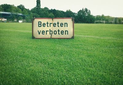 Information sign on grassy field