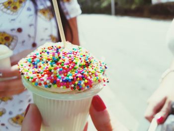 Close-up of hand holding ice cream