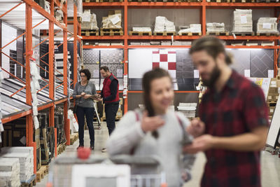 Salesman assisting female customer in hardware store