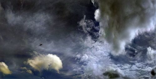 Low angle view of airplane flying against sky