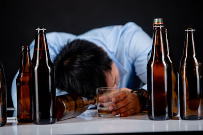 Midsection of man having food in glass