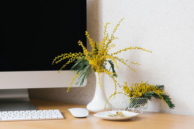 Concept of a business, freelancer, blogger. the laptop is on a wooden table against a white wall