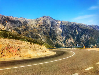 Scenic view of mountains against clear blue sky