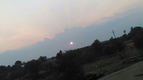 Scenic view of landscape against sky at sunset