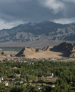 Scenic view of field and mountains against sky