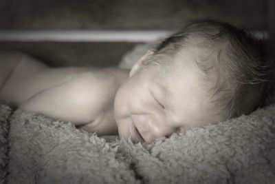 Close-up of baby sleeping on bed